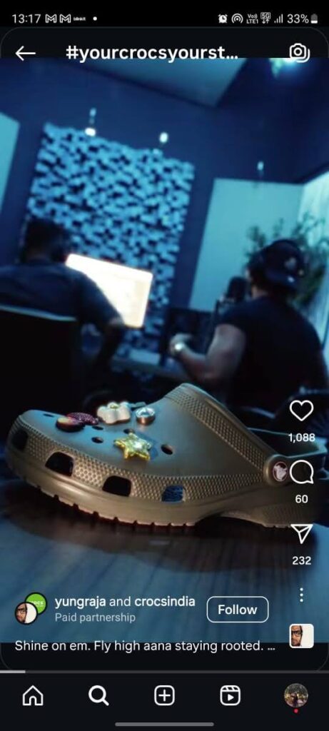 Yung Raja rapping in studio, Crocs matching his vibrant energy.